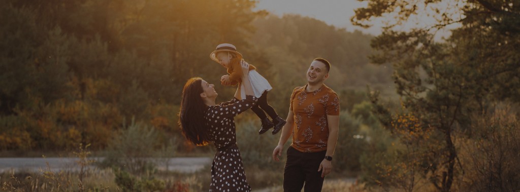Happy family outdoors at sunset